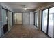 Tiled sunroom with sliding doors leads to a dining area and living space at 15037 Mcgraw Ave, Port Charlotte, FL 33953