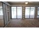 The sunroom is tiled with exposed shelving and large sliding doors that let in plenty of light at 15037 Mcgraw Ave, Port Charlotte, FL 33953