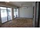 Spacious sunroom with tile floor, ceiling fan, and sliding doors to bring in lots of light at 15037 Mcgraw Ave, Port Charlotte, FL 33953