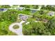 Expansive home featuring a backyard pool, complimented by surrounding verdant trees and serene cul-de-sac at 1546 Gourmet Rd, North Port, FL 34288