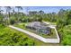 Birds eye view of the house with a screened-in pool and a big white fence in the backyard at 1546 Gourmet Rd, North Port, FL 34288