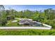 Aerial view of house on wooded lot featuring screened in pool, fenced in yard, and cul-de-sac at 1546 Gourmet Rd, North Port, FL 34288