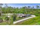 Aerial view of home featuring a white fence, pool, screened in porch, and spacious property at 1546 Gourmet Rd, North Port, FL 34288