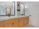 Bathroom featuring a double vanity with marble countertops, and framed mirrors at 1546 Gourmet Rd, North Port, FL 34288