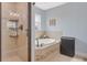 Luxurious bathroom with glass enclosed shower and separate soaking tub at 1546 Gourmet Rd, North Port, FL 34288