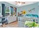 Bright bedroom with ample natural light, musical decor, and modern furnishings at 1546 Gourmet Rd, North Port, FL 34288
