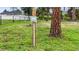 Outdoor electrical box in the backyard with a sturdy wooden post and green surroundings at 1546 Gourmet Rd, North Port, FL 34288