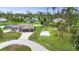 Picturesque home featuring a spacious backyard, complemented by mature trees and ample greenery at 1546 Gourmet Rd, North Port, FL 34288