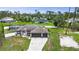 Charming single-story home featuring a spacious driveway, three-car garage, and beautiful landscaping at 1546 Gourmet Rd, North Port, FL 34288