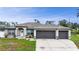 Attractive single-Gathering home with a lush green lawn and a spacious three-car garage at 1546 Gourmet Rd, North Port, FL 34288