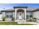Welcoming front entrance with stone accents, decorative wreath, and manicured landscaping at 1546 Gourmet Rd, North Port, FL 34288