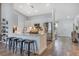 Modern kitchen featuring a marble countertop island with sleek stools, and stainless steel appliances at 1546 Gourmet Rd, North Port, FL 34288
