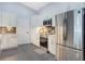 Modern kitchen featuring stainless steel appliances, white cabinets, and tile flooring at 1546 Gourmet Rd, North Port, FL 34288