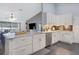 Bright kitchen features white cabinets, stainless steel appliances, marble counters, and open layout at 1546 Gourmet Rd, North Port, FL 34288