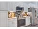 Bright kitchen featuring stainless steel appliances, white cabinets, and modern lighting at 1546 Gourmet Rd, North Port, FL 34288