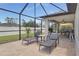 Inviting screened patio with lounge chairs, offering seamless indoor-outdoor living at 1546 Gourmet Rd, North Port, FL 34288