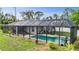 Aerial view of a beautiful pool with a screened enclosure, creating a private backyard oasis at 1546 Gourmet Rd, North Port, FL 34288