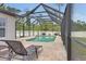 Stunning in-ground pool enclosed within a screened lanai, providing privacy at 1546 Gourmet Rd, North Port, FL 34288
