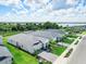 An aerial view of a home with a gray roof, paver driveway, lush green lawn and landscaping at 16336 Preservation Blvd, Punta Gorda, FL 33982
