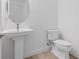 Clean and modern powder room with pedestal sink, toilet, and simple elegant design at 16336 Preservation Blvd, Punta Gorda, FL 33982
