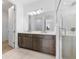 Bathroom features a double sink vanity, shower with glass door, and view into the adjacent room at 16336 Preservation Blvd, Punta Gorda, FL 33982