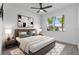 This bedroom offers a cozy area rug and a bright window with views of palm trees and a sunny, neighborhood street at 16336 Preservation Blvd, Punta Gorda, FL 33982