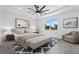This staged bedroom features a tray ceiling, neutral color palette, soft rug, and window with a sunny exterior view at 16336 Preservation Blvd, Punta Gorda, FL 33982