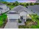 Beautiful single-story home with a two-car garage, brick paved driveway, and manicured landscaping at 16336 Preservation Blvd, Punta Gorda, FL 33982