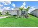 Charming single-story home with a well-maintained front lawn and lush landscaping at 16336 Preservation Blvd, Punta Gorda, FL 33982