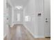 Bright hallway features wood floors, white wall panels and trim at 16336 Preservation Blvd, Punta Gorda, FL 33982
