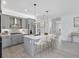 Bright, modern kitchen with stainless steel appliances, gray cabinets, and a central island with bar seating at 16336 Preservation Blvd, Punta Gorda, FL 33982
