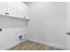 Functional laundry room with white cabinets, offering ample storage space and clean, modern design at 16336 Preservation Blvd, Punta Gorda, FL 33982