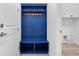 Charming mudroom with blue built-in storage, offering organization and a welcoming entrance space at 16336 Preservation Blvd, Punta Gorda, FL 33982