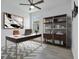 Well-lit home office with modern desk, shelving, and stylish décor, ideal for productivity at 16336 Preservation Blvd, Punta Gorda, FL 33982
