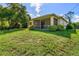 Grassy backyard with a large screened patio offers a beautiful outdoor space at 1693 Jagust Rd, North Port, FL 34288