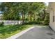Landscaped backyard features a concrete patio and plenty of shade at 1693 Jagust Rd, North Port, FL 34288