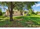Spacious backyard has grass, shade and a screen enclosed patio at 1693 Jagust Rd, North Port, FL 34288