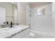 Bright bathroom features a tub, shower, and granite vanity top at 1693 Jagust Rd, North Port, FL 34288
