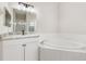 Bright bathroom featuring a vanity with granite countertop and a large soaking tub at 1693 Jagust Rd, North Port, FL 34288