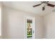 A well-lit bedroom featuring a ceiling fan, neutral walls, and a glass door for outdoor access at 1693 Jagust Rd, North Port, FL 34288