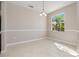 Dining area featuring neutral walls, a chandelier, and a window with a tropical view at 1693 Jagust Rd, North Port, FL 34288