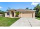 Attractive single-Gathering home with a manicured lawn and an attached two-car garage at 1693 Jagust Rd, North Port, FL 34288