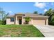 Charming single-story home with a well-maintained lawn, two-car garage, and welcoming curb appeal at 1693 Jagust Rd, North Port, FL 34288