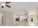 Bright kitchen featuring stainless steel appliances, tile backsplash, and a breakfast bar overlooking the living space at 1693 Jagust Rd, North Port, FL 34288
