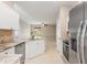 Spacious kitchen featuring stainless appliances, a breakfast bar, and open layout to the living room at 1693 Jagust Rd, North Port, FL 34288