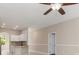 Open-concept living area featuring tile flooring, neutral paint, and views into the kitchen at 1693 Jagust Rd, North Port, FL 34288