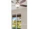 Bright living room with tiled floors, a ceiling fan, and sliding glass doors to the screened porch at 1693 Jagust Rd, North Port, FL 34288