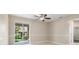 Neutral living room with tiled floors, a ceiling fan, and sliding glass doors to the screened porch at 1693 Jagust Rd, North Port, FL 34288