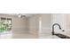 Living space featuring a ceiling fan and sliding doors to a screened lanai, flowing to kitchen at 1693 Jagust Rd, North Port, FL 34288
