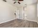 Spacious main bedroom showcasing wood floors, neutral paint, and access to the ensuite bathroom at 1693 Jagust Rd, North Port, FL 34288